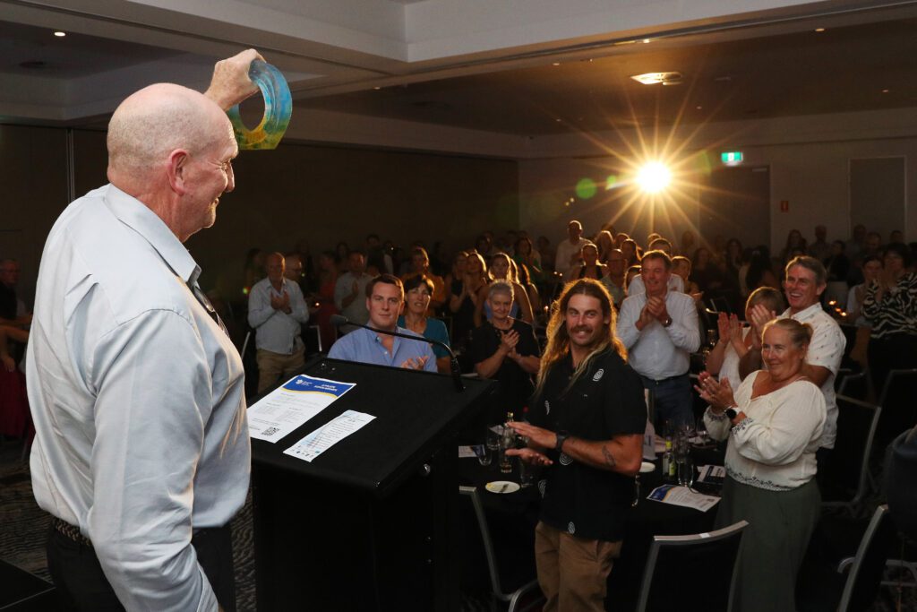 Coach Matt Horsnell accepting the Sportsperson of the Year Award on behalf of Nicola Olyslagers